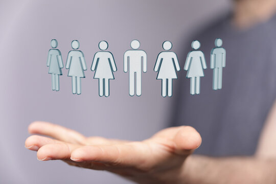Hand holding human figures representing teamwork, diversity, and community. Concept of unity and togetherness in a mode