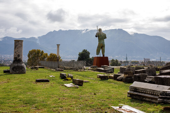 Modern bronze statue with mountain landscape in Pompeii Archaeological Park Italy