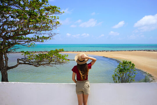 Tourist woman enjoying panoramic view from Saint Francis Fort in Olinda, Pernambuco, Brazil