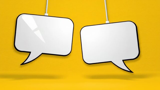 Two shiny white speech bubbles hanging against a yellow wall backdrop for dialogue or conversation prompts