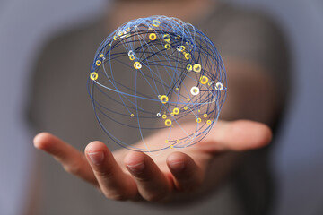 Abstract image showing a global network sphere held in the palm of a hand. Concept of connection, communication, and gl © vegefox.com