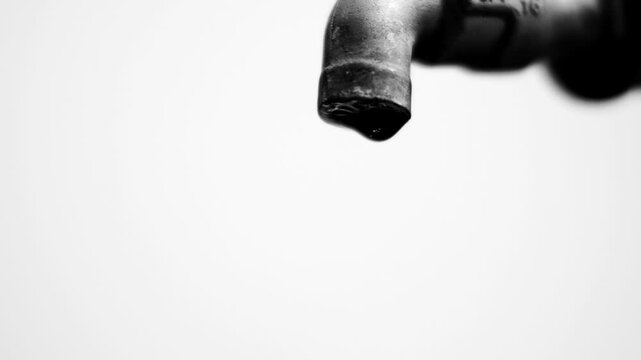 Close-up of a dripping faucet, symbol of water conservation