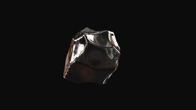 Faceted irregular metallic object with bronze reflections isolated on black background presenting a dramatic minimal futuristic 3D render with sharp planes and texture