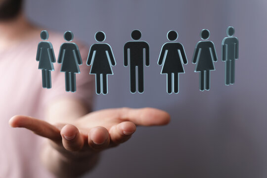 Hand holding human icons, symbolising community, teamwork, and support. A concept of people, connection and working tog