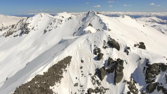Aerial perspective shows Kackar peaks, snowbound ridges across North Anatolia, Black Sea Turkey. Overhead panorama reveals icy summits and glacier carved slopes near Rize, Pontic Alps wilderness.