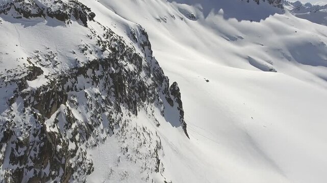 Aerial perspective shows Kackar peaks, snowbound ridges across North Anatolia, Black Sea Turkey. Overhead panorama reveals icy summits and glacier carved slopes near Rize, Pontic Alps wilderness.