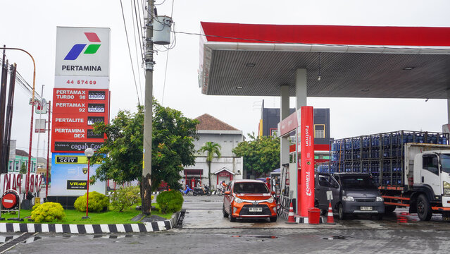 The situation at the pertamina gas station or spbu saw lots of cars and trucks queuing up to refuel. A filling station, also known as petrol or gas station. Car, truck, motorcycle.