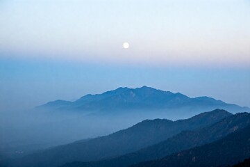 Full Moon Over Misty Mountain Range