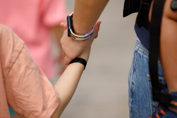 Father holding child's hand while sightseeing, symbolizing bonding and protection, hand skin texture, close up, at Wat Arun.