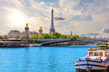 Paris sunset view with Eiffel Tower and Alexandre III Bridge over river Seine, France