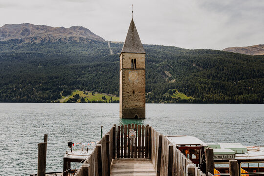 Famous half sunken 14th century church bell tower in Lake Reschen (Reschensee) at Curon Venosta, South Tyrol, Italy