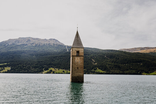 Famous half sunken 14th century church bell tower in Lake Reschen (Reschensee) at Curon Venosta, South Tyrol, Italy