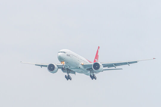 Mai Khao Phuket Thailand 2025 11 25: Nordwind Airlines Boeing 777-200ER prepares to land over Mai Khao Beach, approaching Phuket Airport in Thailand on a clear day with a blue sky.