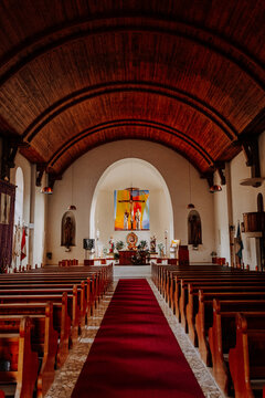 Interior view of the Maria Himmelfahrt parish church with wooden ceiling and altar in Siusi (Seis), Italy