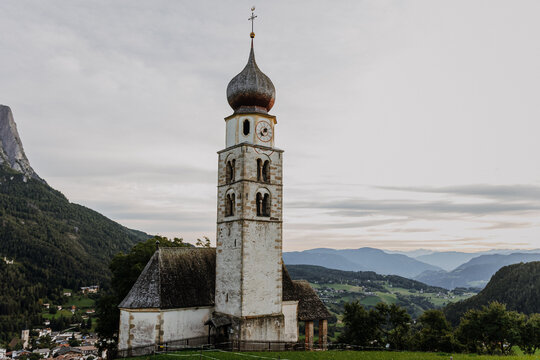 Scenic view of the historic St. Valentin church (San Valentino) in Seis with the majestic Sciliar (Schlern) mountain peak, Dolomites, South Tyrol, Italy
