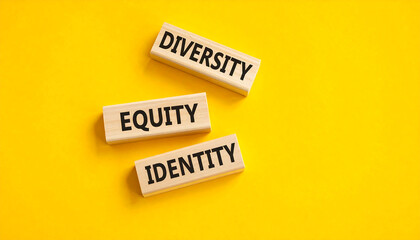 Diversity equity identity wooden blocks on yellow background