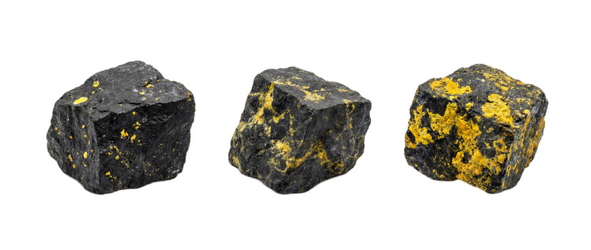 Collection of three distinct raw uranium ore samples isolated with no background demonstrating natural radioactive mineral variety for physics education and scientific reporting
