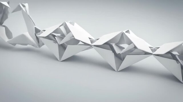 White paper transforms into intricate origami shapes. These elegant geometric forms create a beautiful chain.