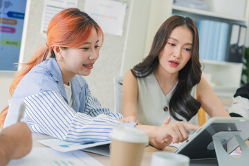 Obraz premium Business professionals discussing strategy in office meeting using tablet analytics and reports, teamwork collaboration analyzing market data, corporate planning session driving innovation, productivi