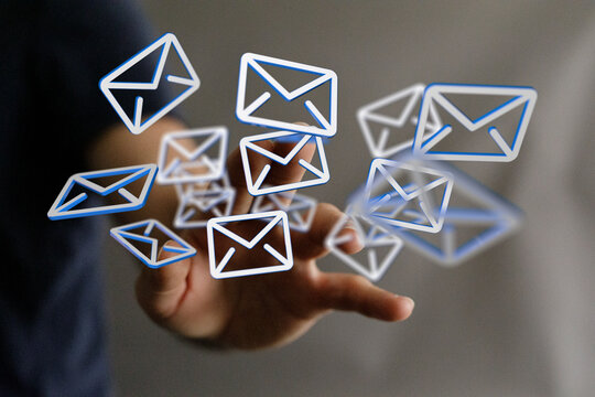 Digital concept of email, communication, and connections. Hand reaching for mail envelopes. Technology, social, interne
