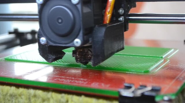 3D printer. 3D printer printing object close-up. 3D printer printing model green color. Working 3D printer. Concept printing technology. New modern additive progressive technology. FDM technologies