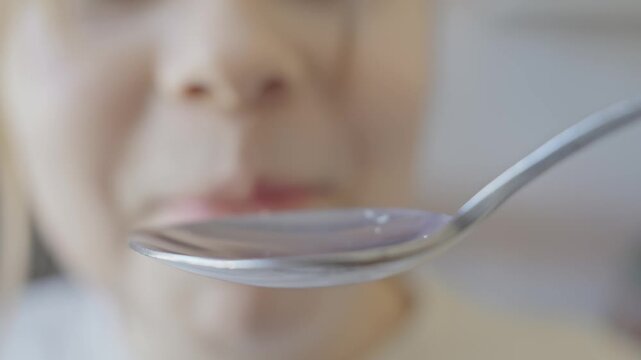 Child eagerly prepares to enjoy spoonful of peanuts, showcasing happiness and curiosity. Spoon POV. Each frame reveals their playful anticipation and enjoyment in cozy kitchen. Close-up in 4K, UHD