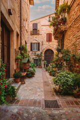 Fototapeta premium Picturesque medieval courtyard street with flowers and arches