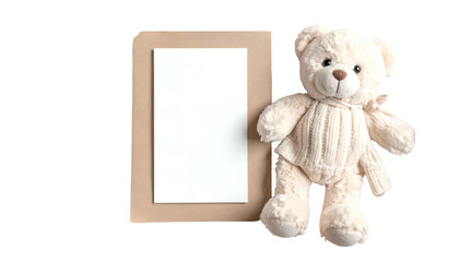 A plush teddy bear sits next to a blank white card resting atop a brown background