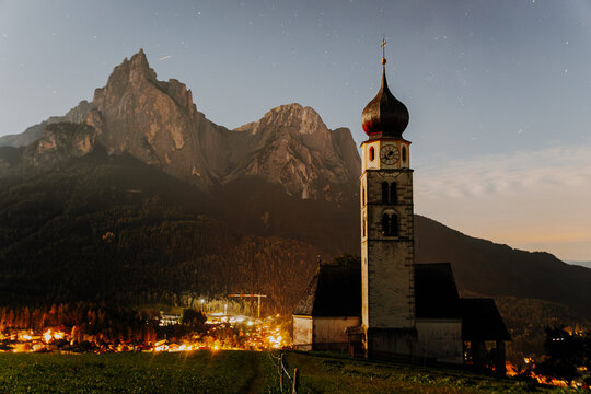 St. Valentin Church with Onion Dome at Night &ndash; Historic Alpine Chapel and the Schlern Mountain under Starry Sky in Castelrotto, South Tyrol