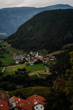 Scenic Aerial View of Castelrotto Village in South Tyrol &ndash; Traditional Alpine Architecture and Lush Green Mountain Valley in the Dolomites