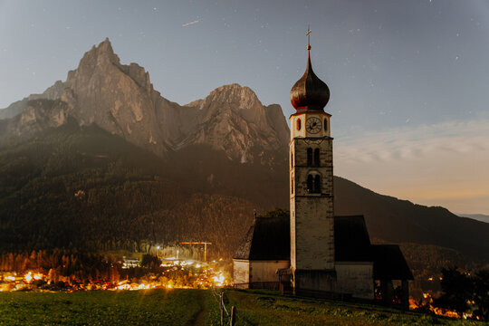 St. Valentin Church with Onion Dome at Night &ndash; Historic Alpine Chapel and the Schlern Mountain under Starry Sky in Castelrotto, South Tyrol