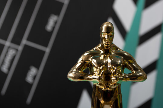 Oscar statue with clapperboard on green background, prize for filmmaking success, celebrating winners in the movie industry, symbol of Hollywood excellence,Moscow, Russia, January 21, 2025