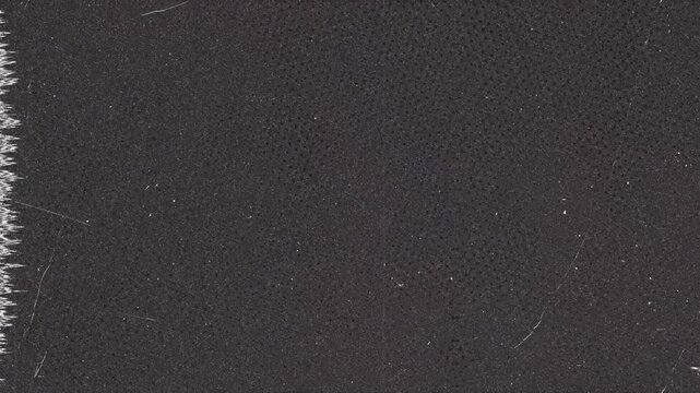 Dark Textured Surface with Dot Pattern and Jagged Edge