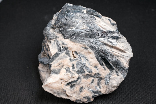 Black metallic crystal cluster in pale host rock