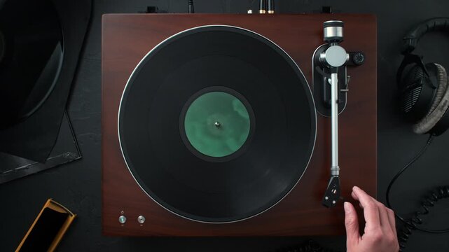 Audiophile Playing a Vinyl Record - Turning on the Turntable, Positioning and Lowering the Tonearm Using a Cue Lever - Top View
