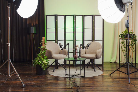 Podcast setup with two chairs and a microphone in a stylish space for recording conversations