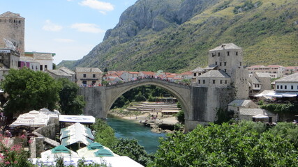 Naklejka premium Mostar / Bosnia and Herzegovina - July 19, 2016: The Old Bridge, Stari Most, with the emerald river Neretva.