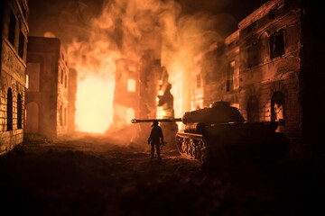 Obraz premium War Concept. Military silhouettes fighting scene on war fog sky background, World War Soldiers Silhouette Below Cloudy Skyline At night. Battle in ruined city.