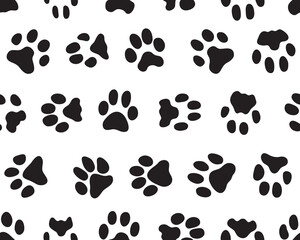 Fototapeta premium Black silhouettes of prints of dog paws, Seamless pattern 