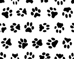 Fototapeta premium Black silhouettes of prints of dog paws, Seamless pattern 