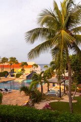 Fototapeta premium Tropical luxury resort pool with palm trees at sunset