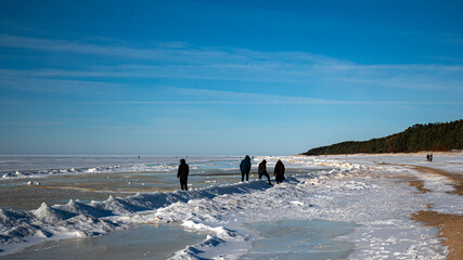 Wonderful view of the frozen sea coast in winter, Baltic Sea surface with beautiful snow patterns , rocky coast