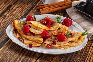 Sweet homemade pancakes with raspberry