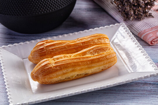Sweet baked eclair dessert with cream