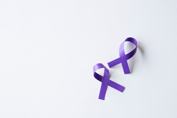 Two purple awareness ribbons on a clean white background.