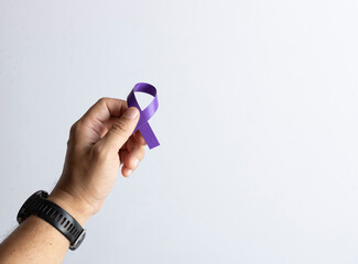 Hand Holding Purple Awareness Ribbon on White Background for Cancer Support Campaign
