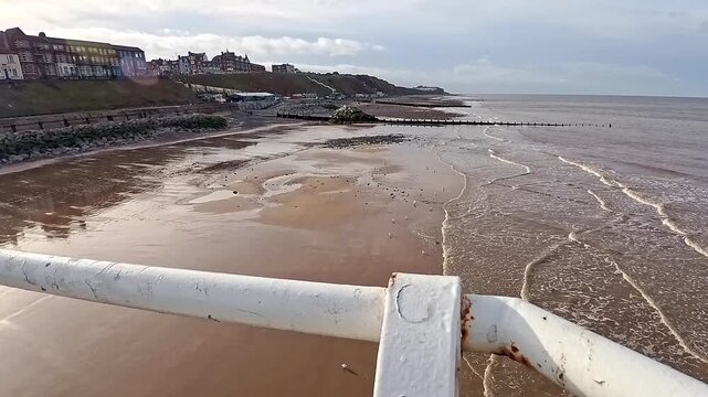 Push in shot of Cromer beach on the North Norfolk coast. Captured from above on the Victorian pier
