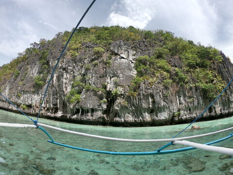 Beautiful landscape scenery in El Nido, Philippines. Filipino wooden boat trip at sunset.