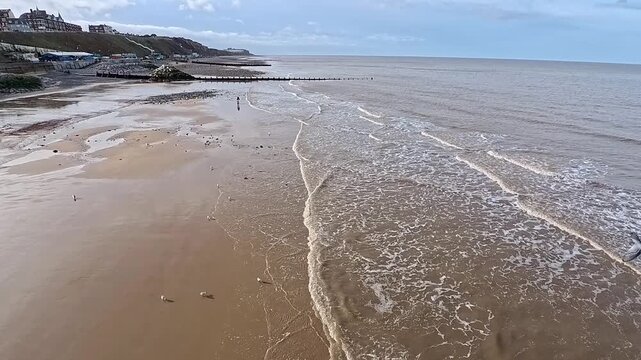 High up view over Cromer Beach on the North Norfolk Coast. Hyper lapse captured from the pier. 