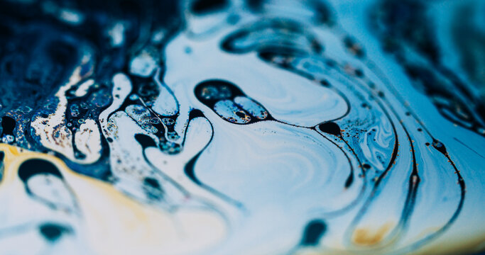 Swirl soap blur. Ink wave. Color pigment drop curl gasoline flow. Blue white yellow oil liquid stream abstract background texture.
